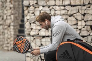 Alejandro Ruiz on bench with Adidas padel racket & bag