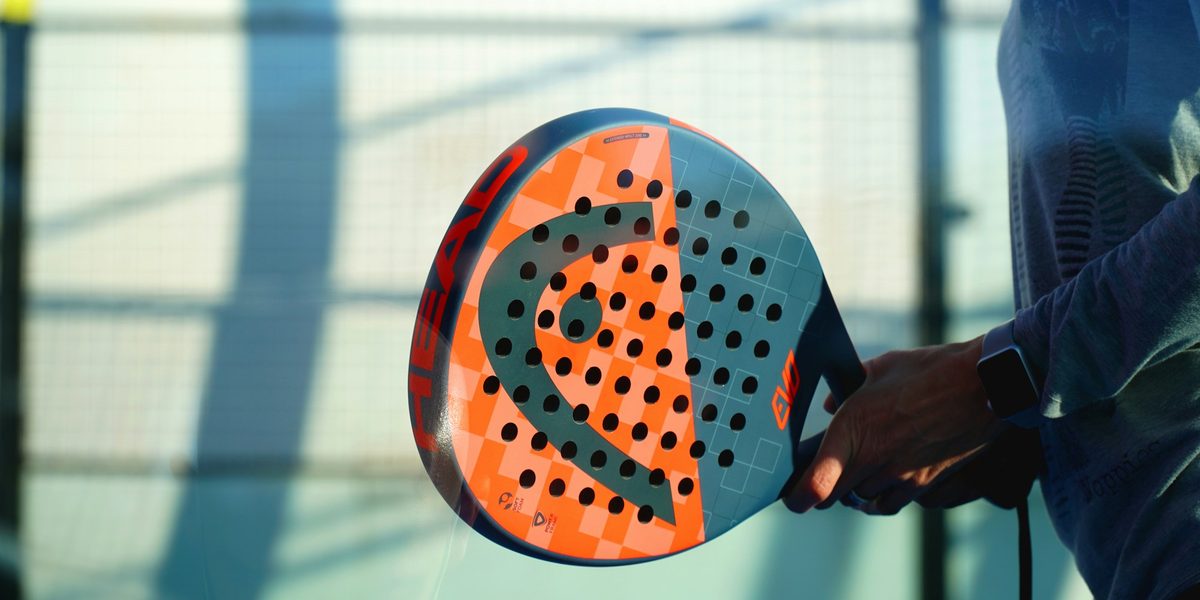 Padel racket and ball on court