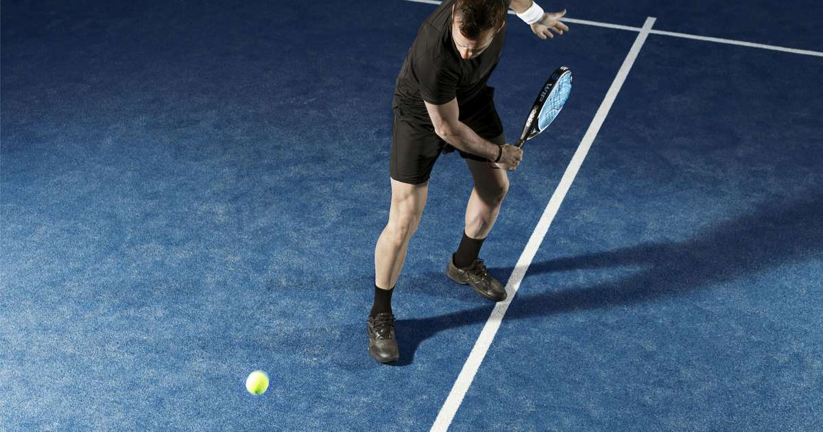 Padel player on a blue court