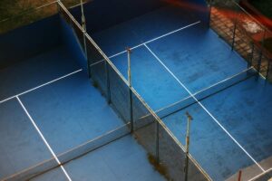 Players on an enclosed glass padel court