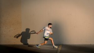 A player on an enclosed squash court
